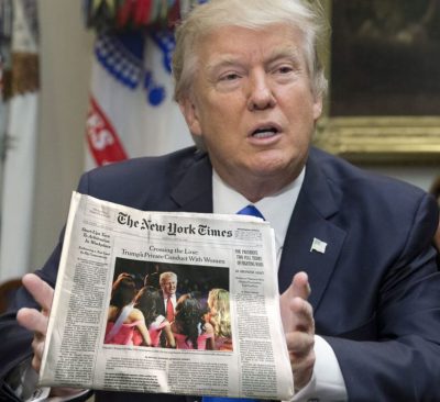 Donald Trump holding a copy of the New York Times